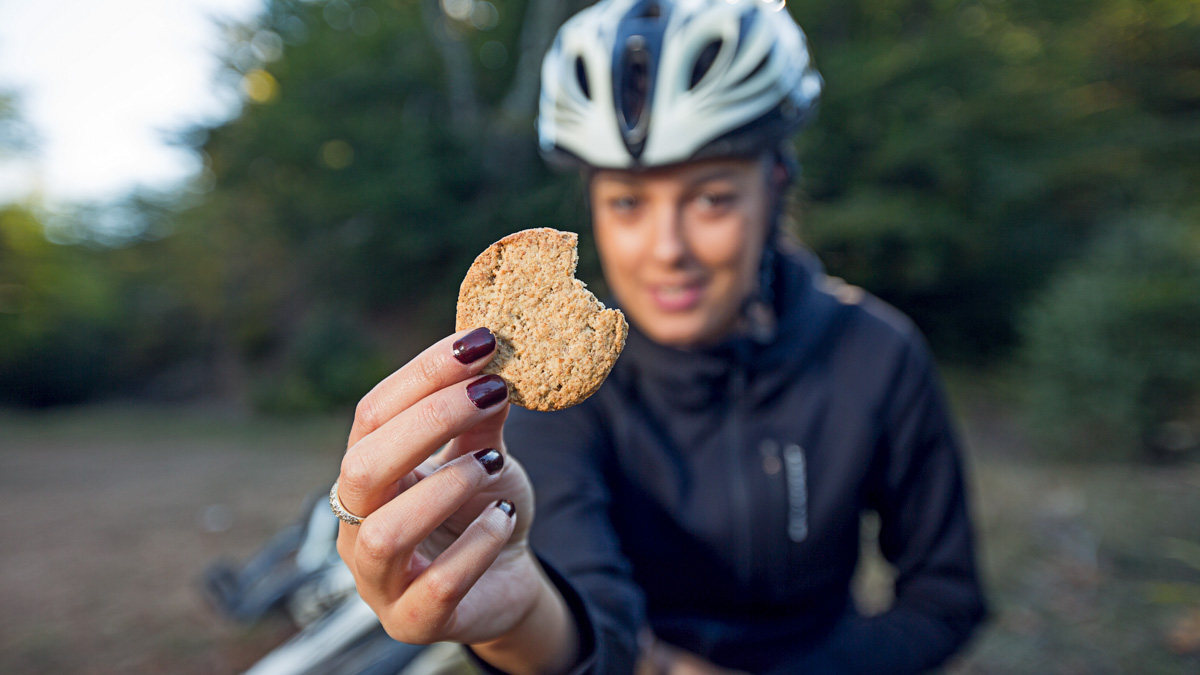Female Cyclist Eating Integral Biscuit