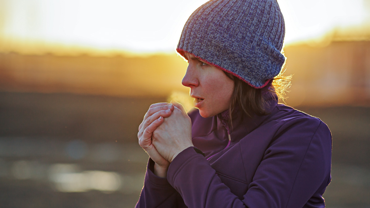 A Girl In Sports Clothes Breathes In The Palm Of Her Hand Trying