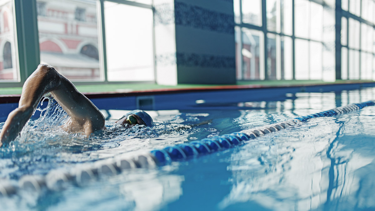 Image Of Sports Man Swimming In Pool Indoors
