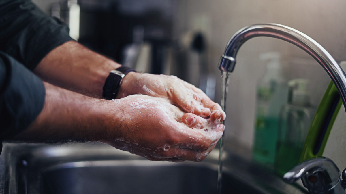 Man Washing Hand With Kitchen Sink Faucet