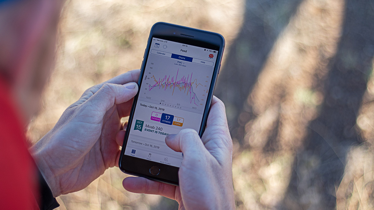 A Coach Looking At The Pmc In The Trainingpeaks App On A Mobile Phone