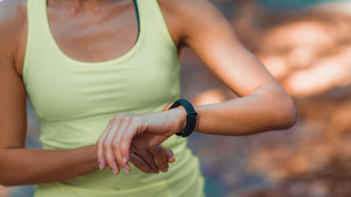 Woman Looking At Smart Watch After Outdoor Training