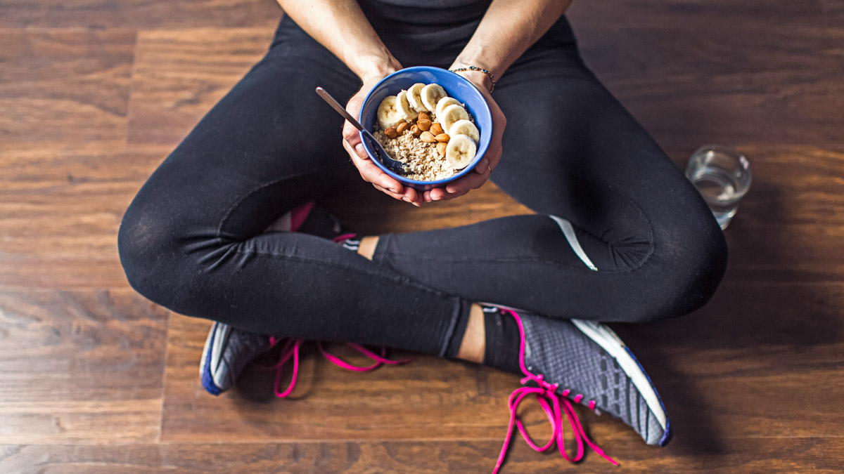 Fitness Woman Eating Oatmeal Porridge