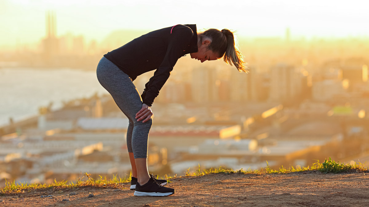 Exhausted Runner Resting After Running In City Outskirts