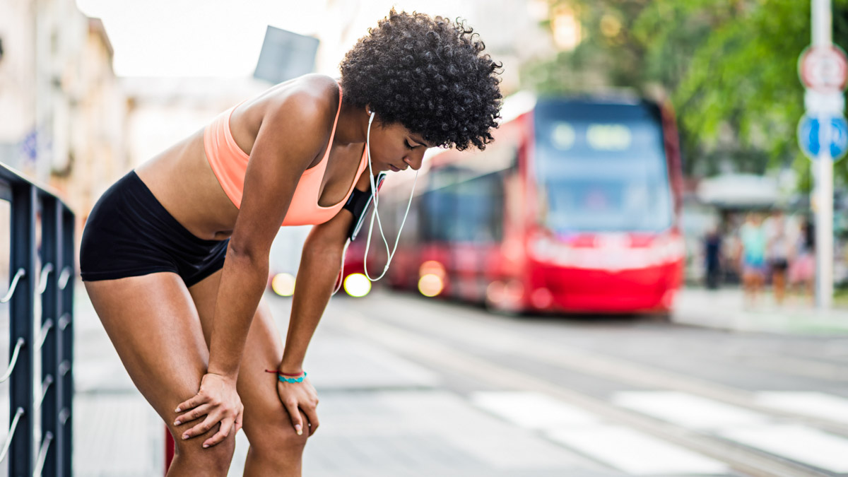 Young Exhausted Sportswoman Catching Up Breath