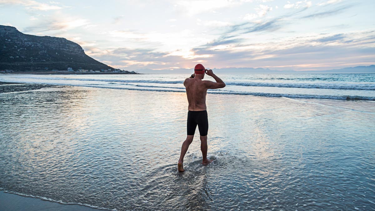 Senior Man Preparing To Swim In The Sea At Dawn