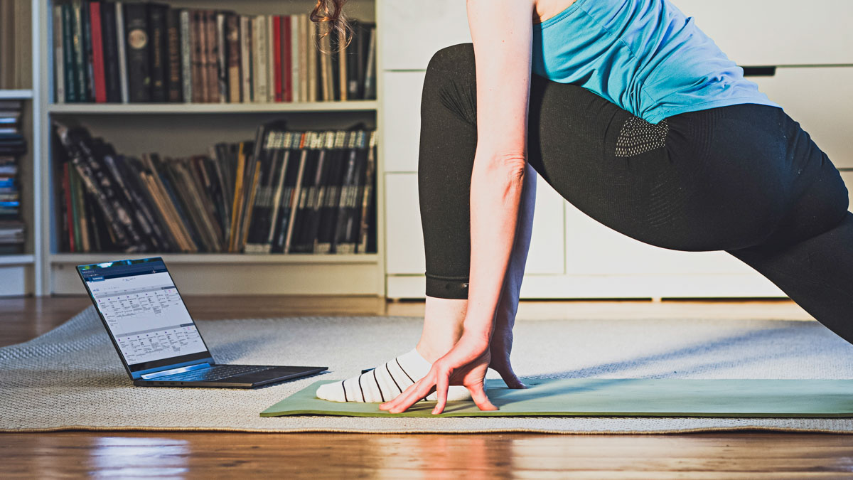 Home Workout Concept Woman In Living Room With Laptop And Dumbe