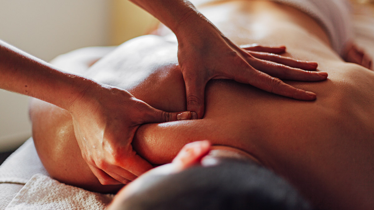 Close Up Of Masseur’s Hands Massaging A Client’s Back