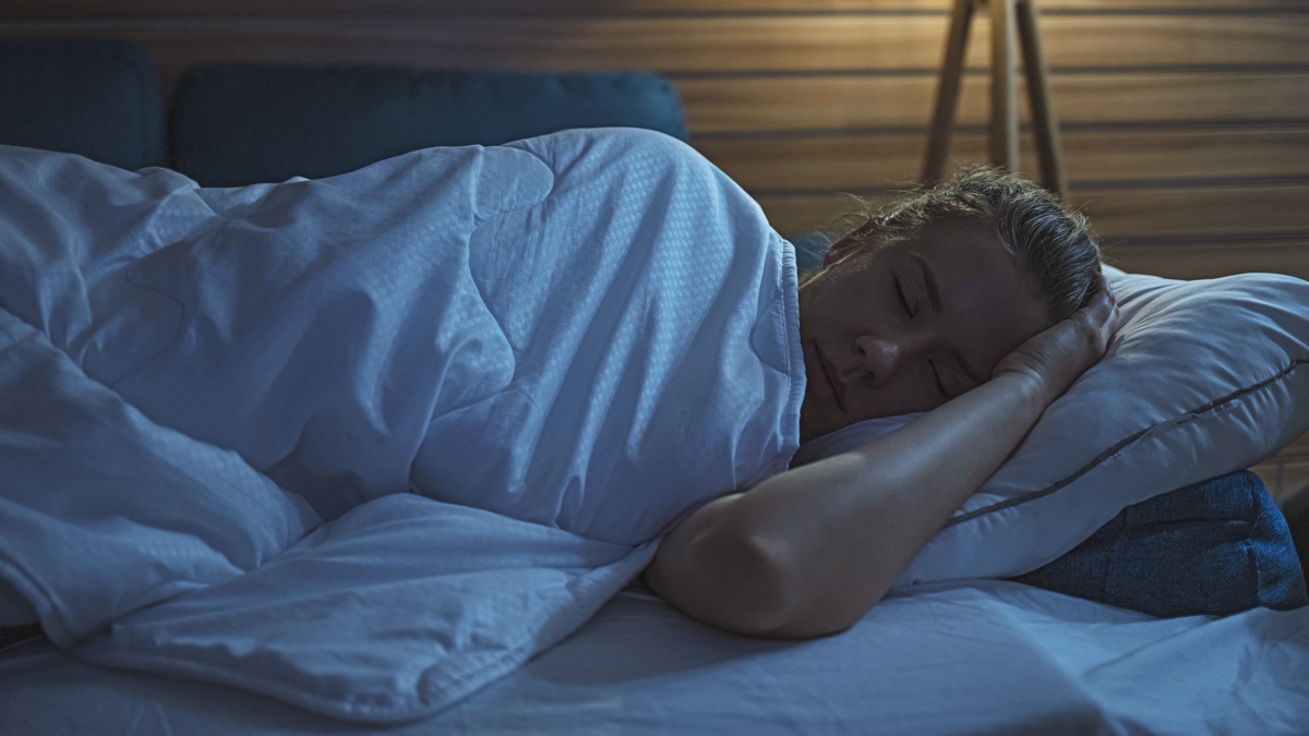 Woman Peacefully Sleeping In Bed