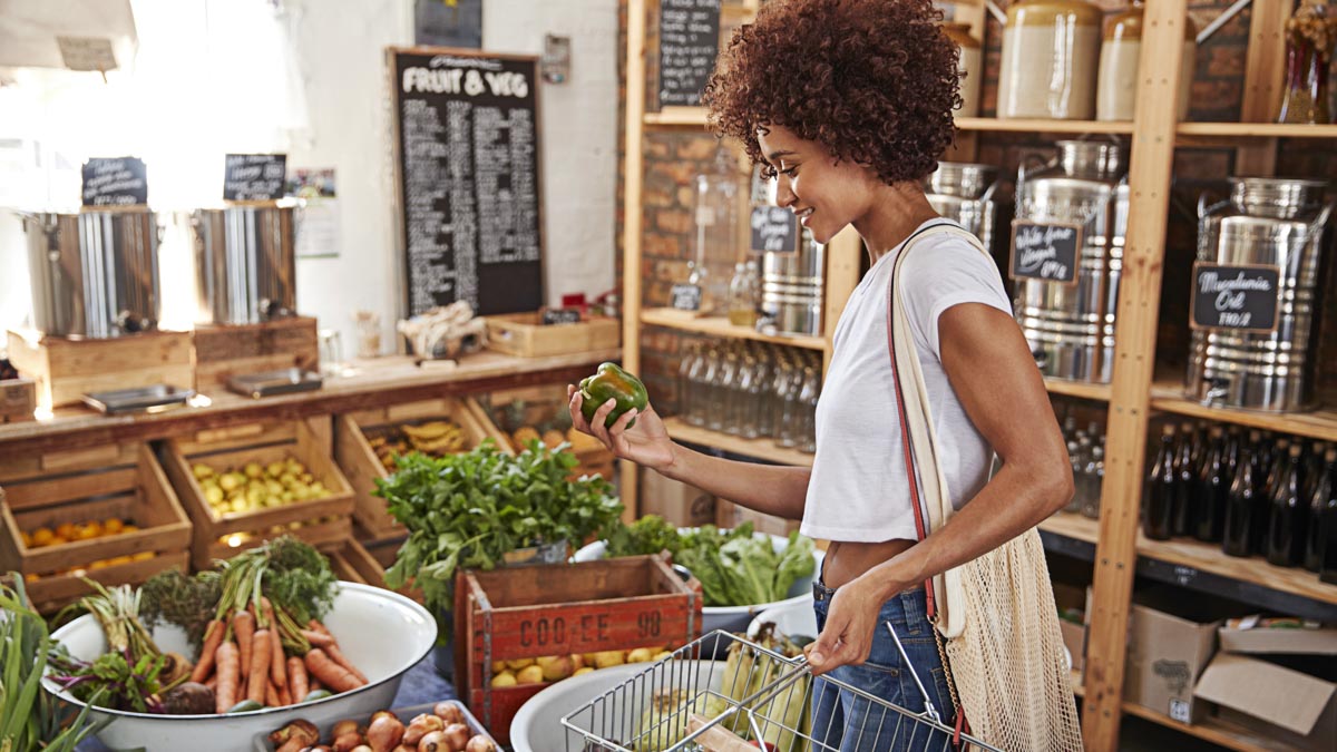 Attractive Black Woman Shops For Produce At A Grocery Store