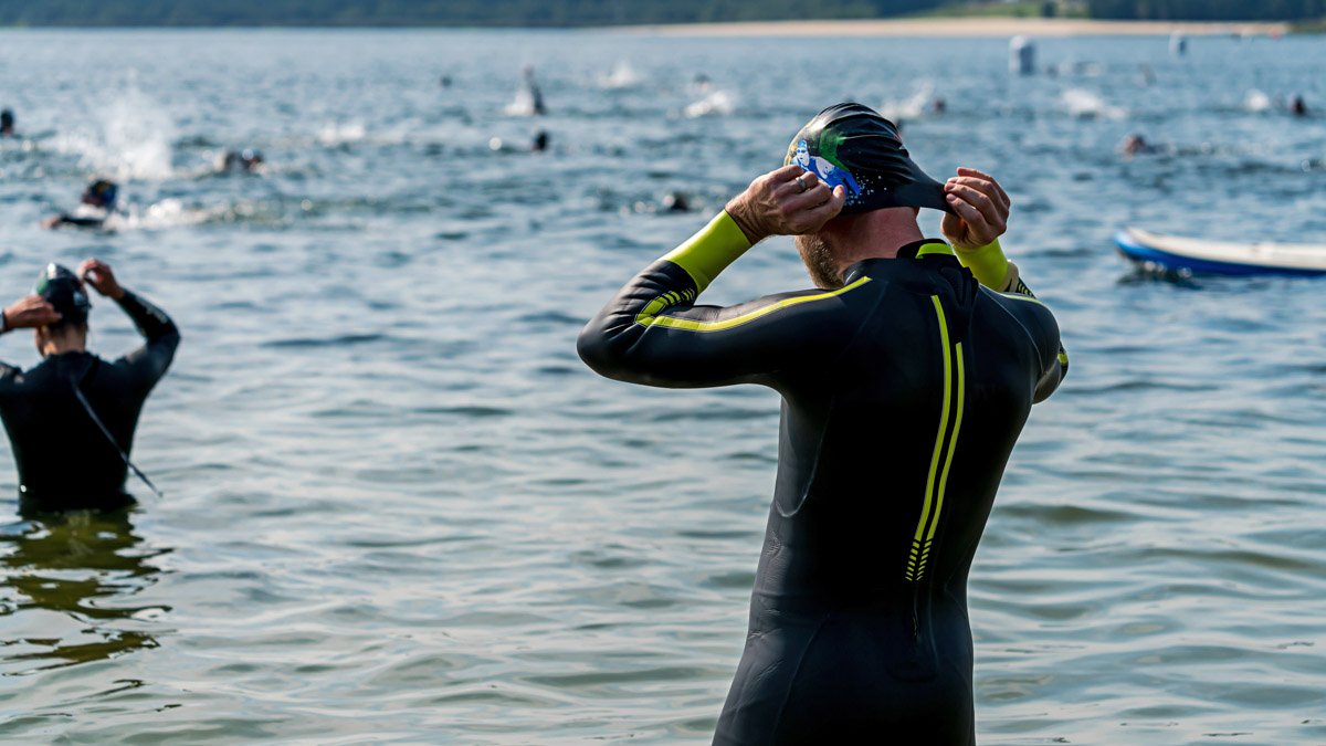 Triathlete In A Wetsuit Getting Ready To Swim Right Before A Triathlon