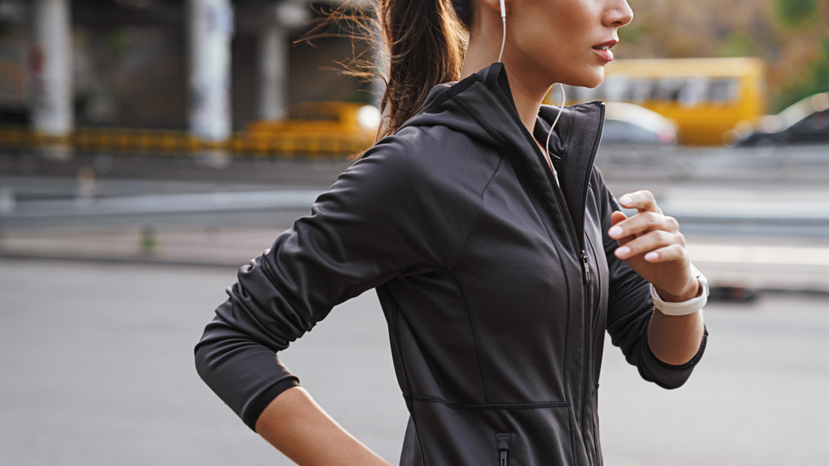 Image Of A Young Gorgeous Strong Sports Woman Running Outdoors By Street Listening Music.