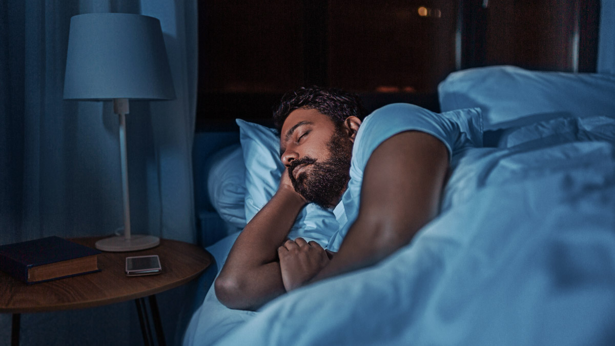 South Asian Man Sleeping In Bed