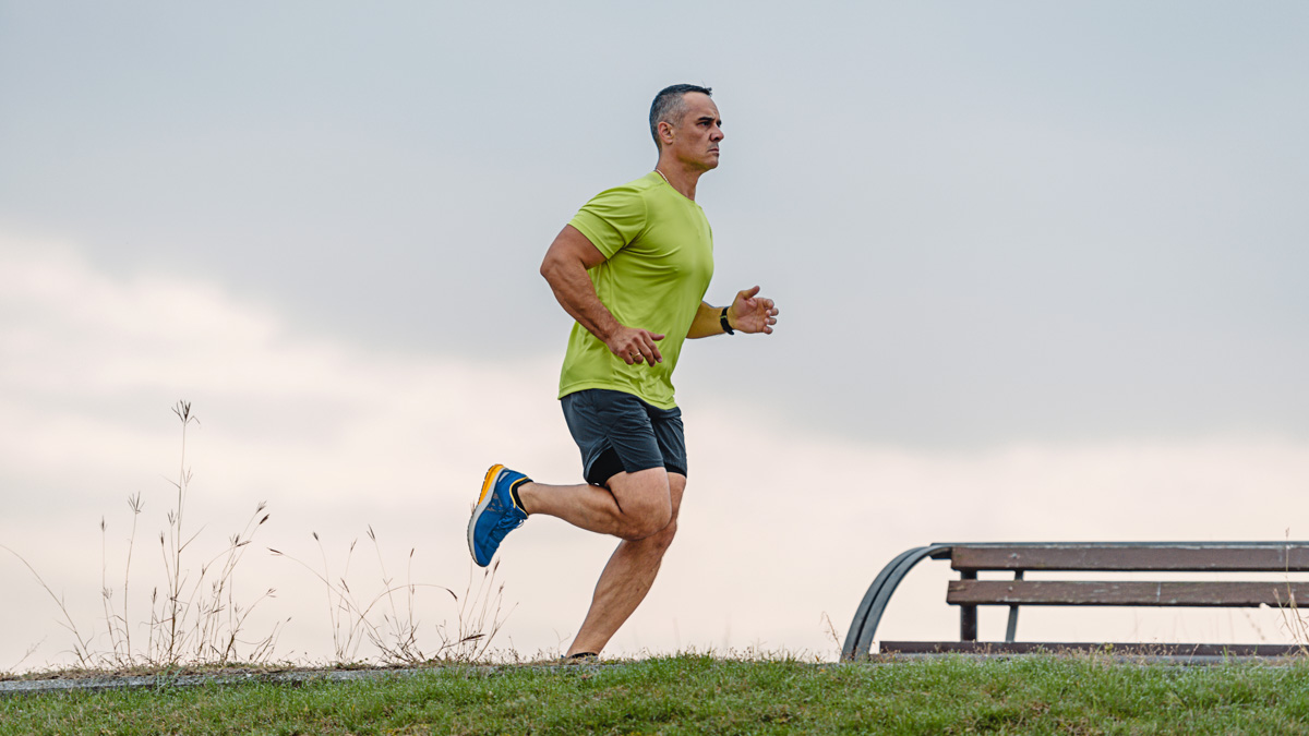 Middle Aged Man Running In A Park Performing A Base Training Workout