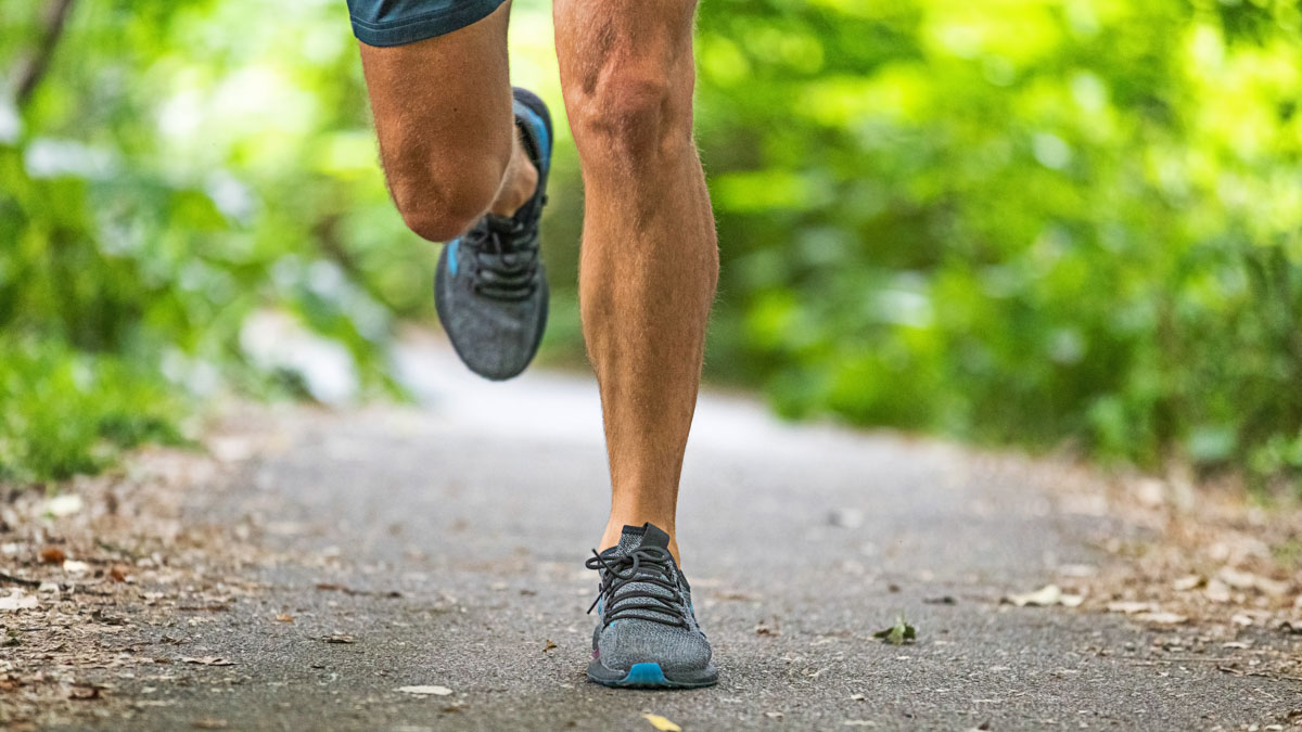 Image Of Male Runner's Legs As He Completes A Recovery Run