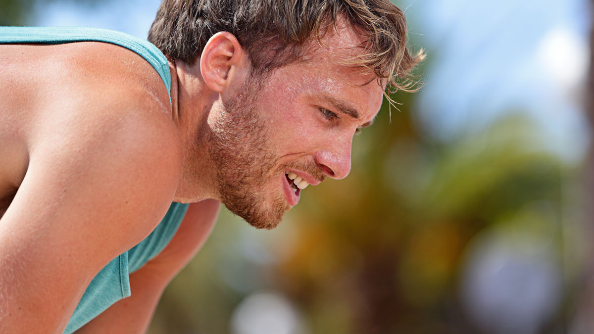 Male Runner Stops To Take A Break Because It's Too Hot To Run Outside