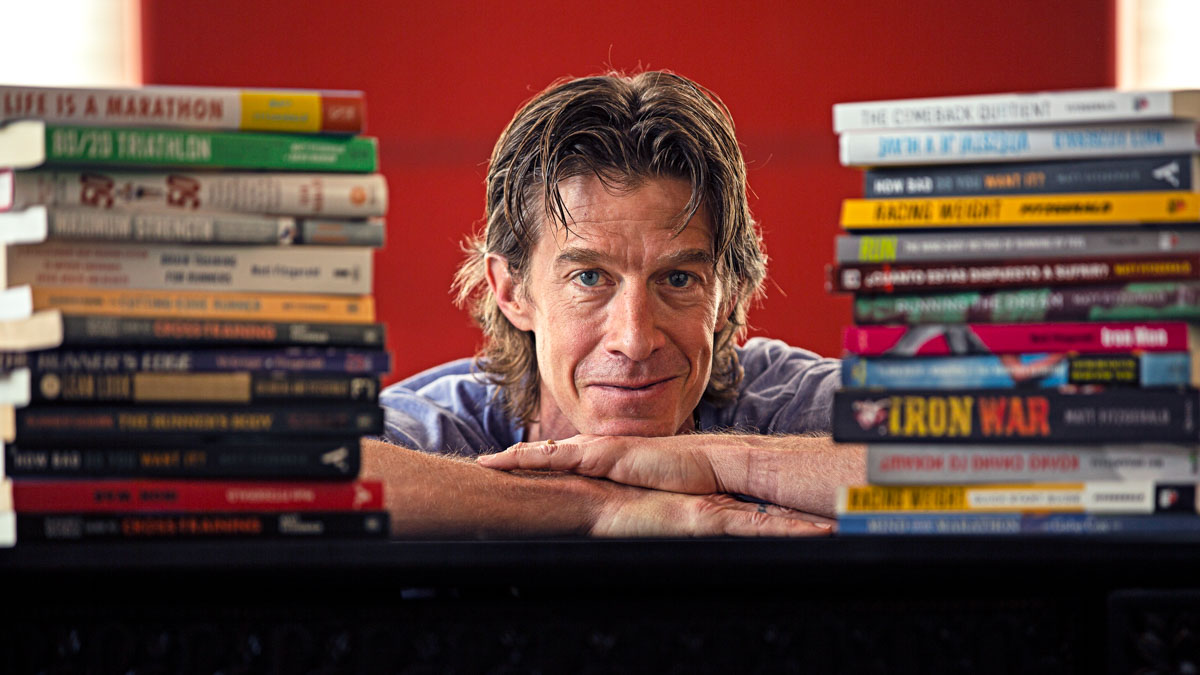 Image Of 80/20 Endurance Coach Matt Fitzgerald Author Surrounded By His Books