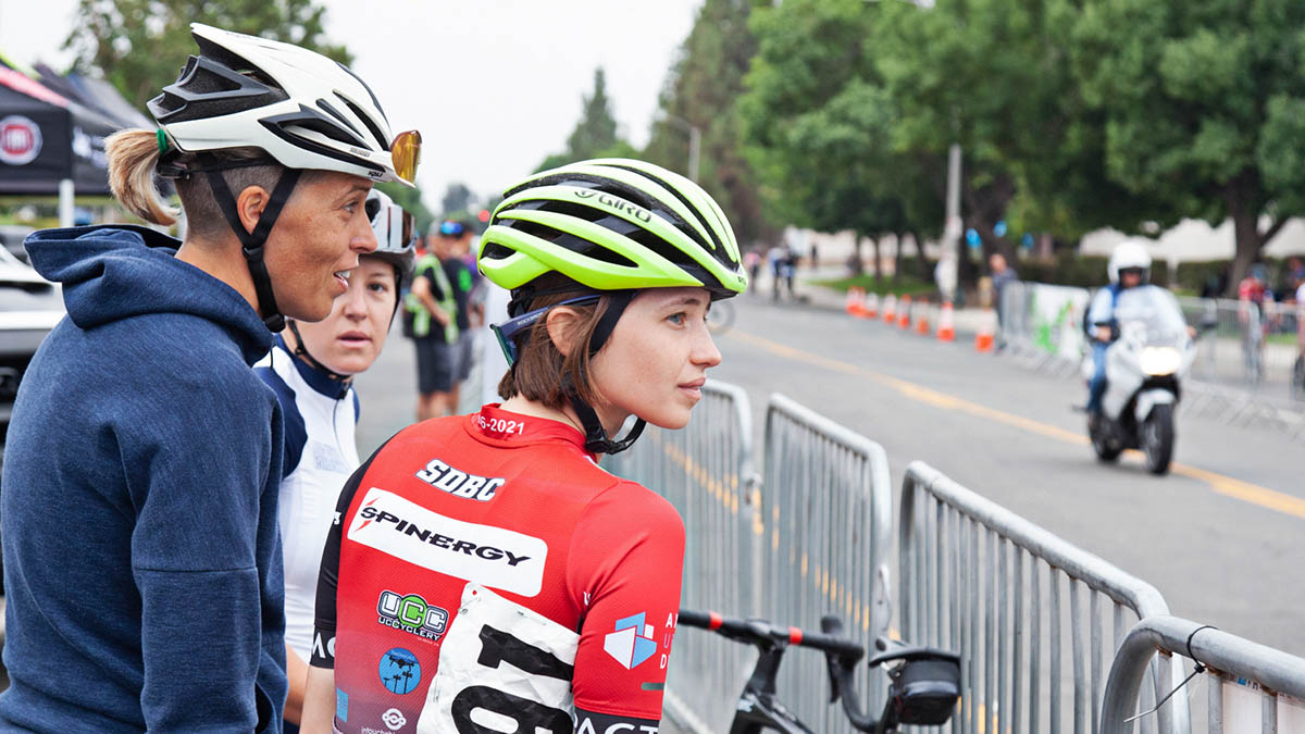 A Female Coach Talks With Her Junior Cycling Racers At A Bike Race