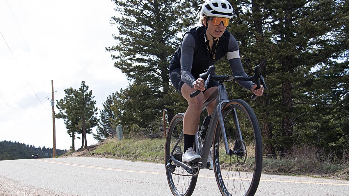 Competitive Female Cyclist Athlete Riding Down The Street During A Workout As Part Of Her Off Season Training