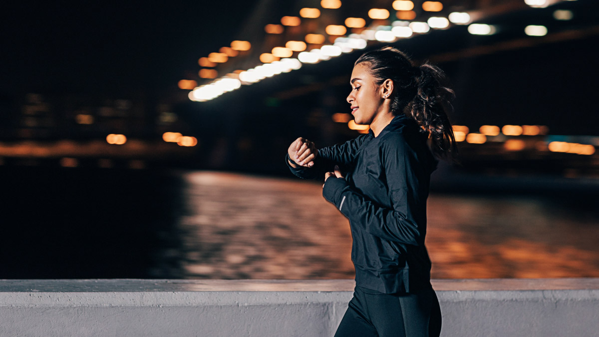 Image Of A Young Woman Going On A Run In The Dark To Get The Benefits Of Working Out At Night