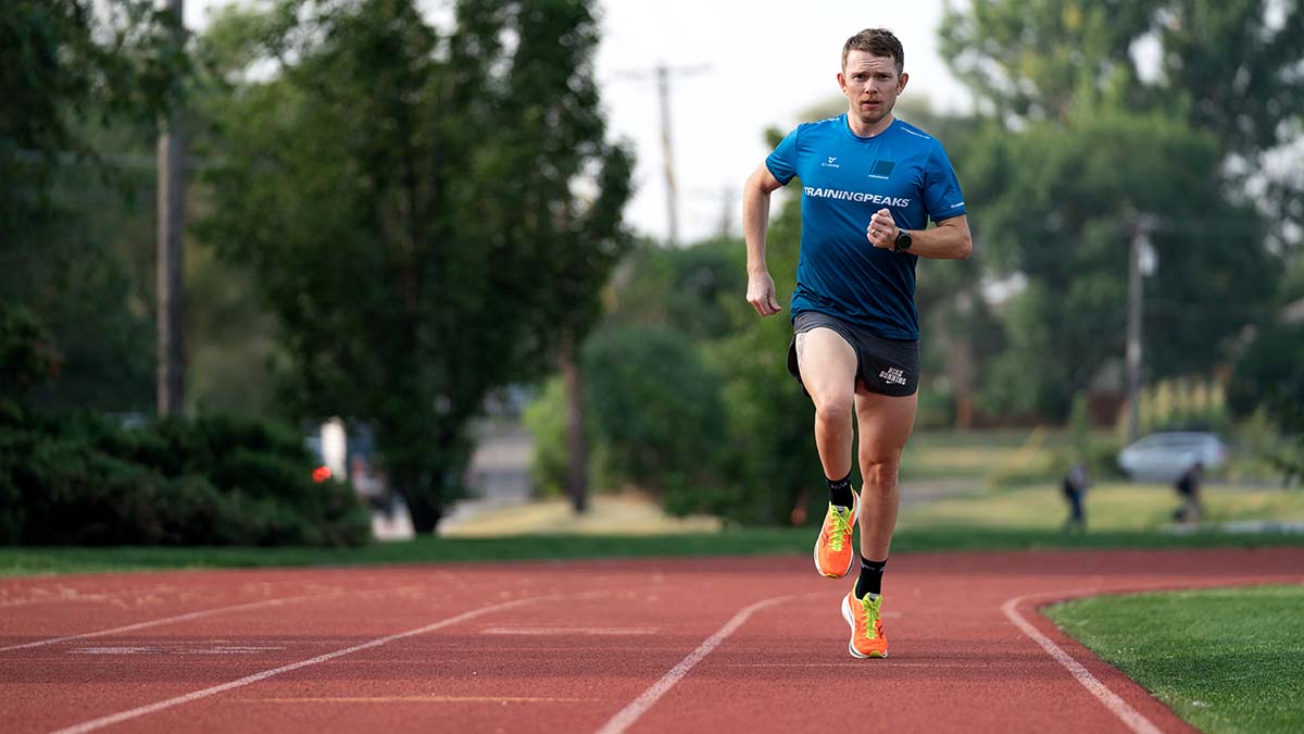 A Man Running On A Track With A Trainingpeaks Jersey On