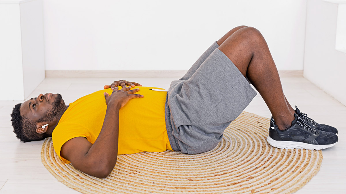 Young Active Afro American Male Laying On The Floor Practicing Breathing Deeply