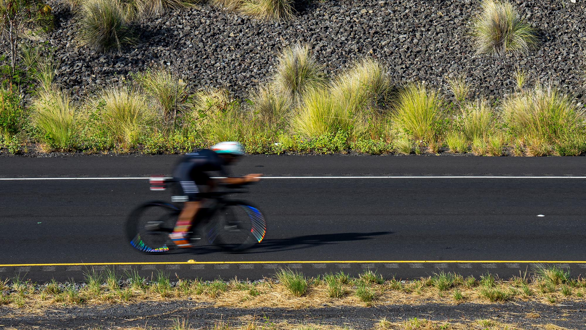 A Cyclist Is A Blur In A Slow Shutter Image Of A Highway Near Kona, Hi.