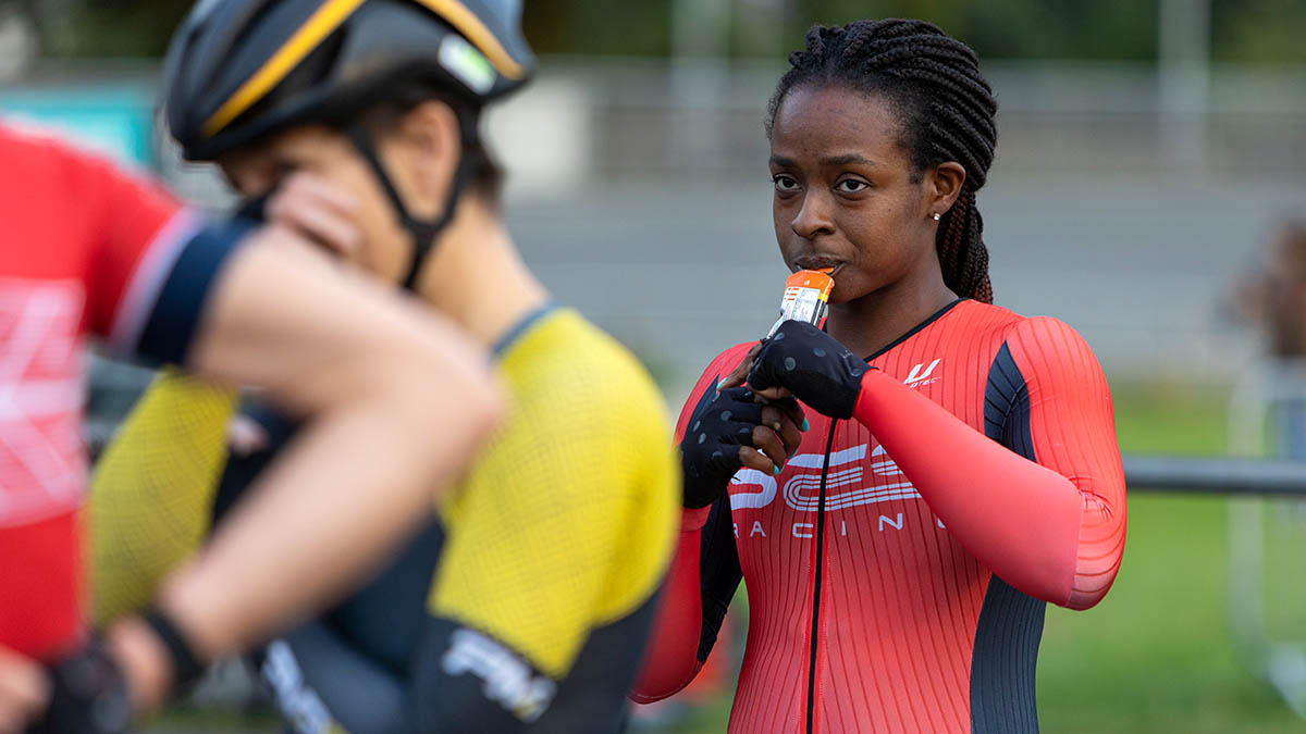 A Black Female Cyclist Eats Some Sports Nutrition While Taking A Break During A Training Session