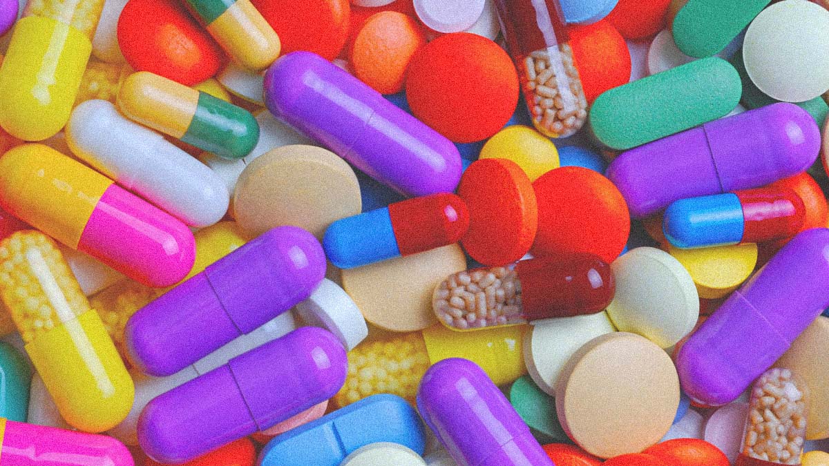 A Table Top Full Of Random Pills And Medications In Dozens Of Colors