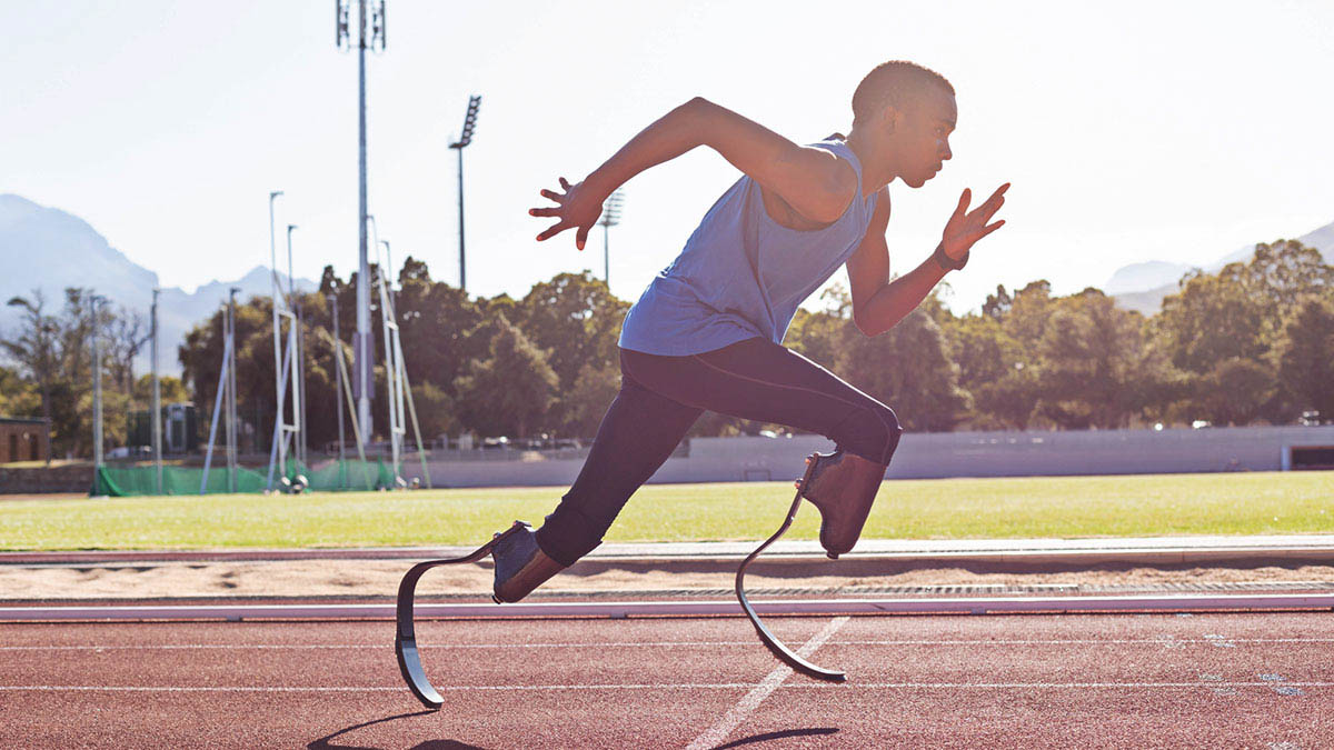 Black Male Athlete With Prosthetic Legs Running On A Track