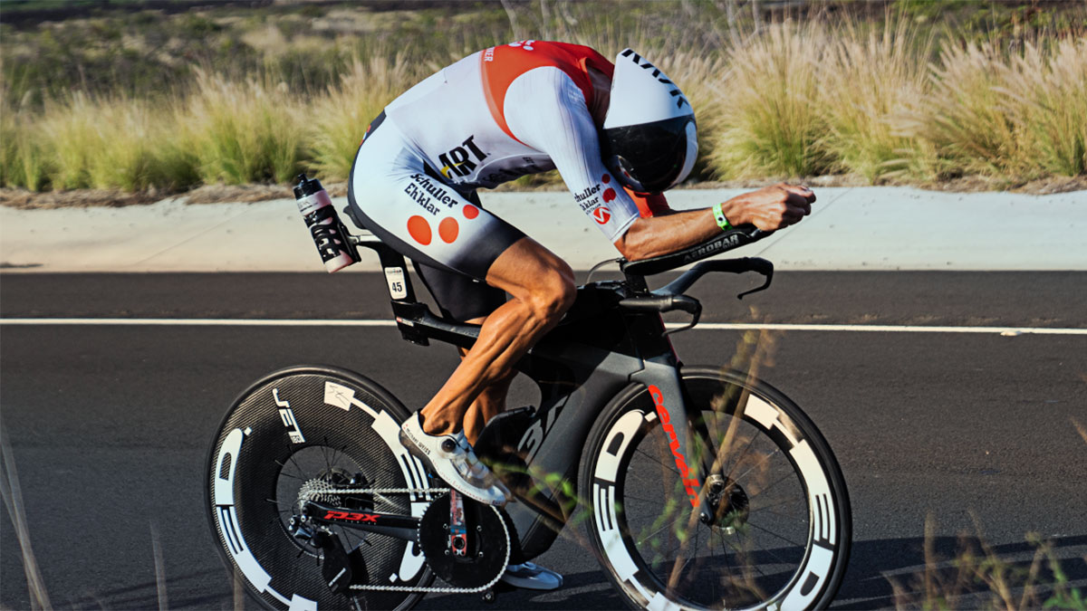 A Male Triathlete In A Full Tuck On The Bike During A Race